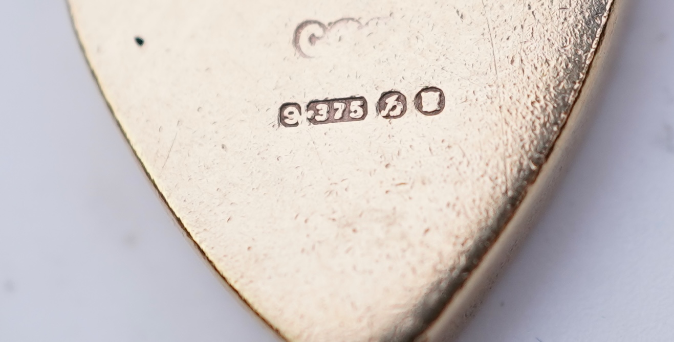 A 9ct gold charm bracelet, mid 20th century